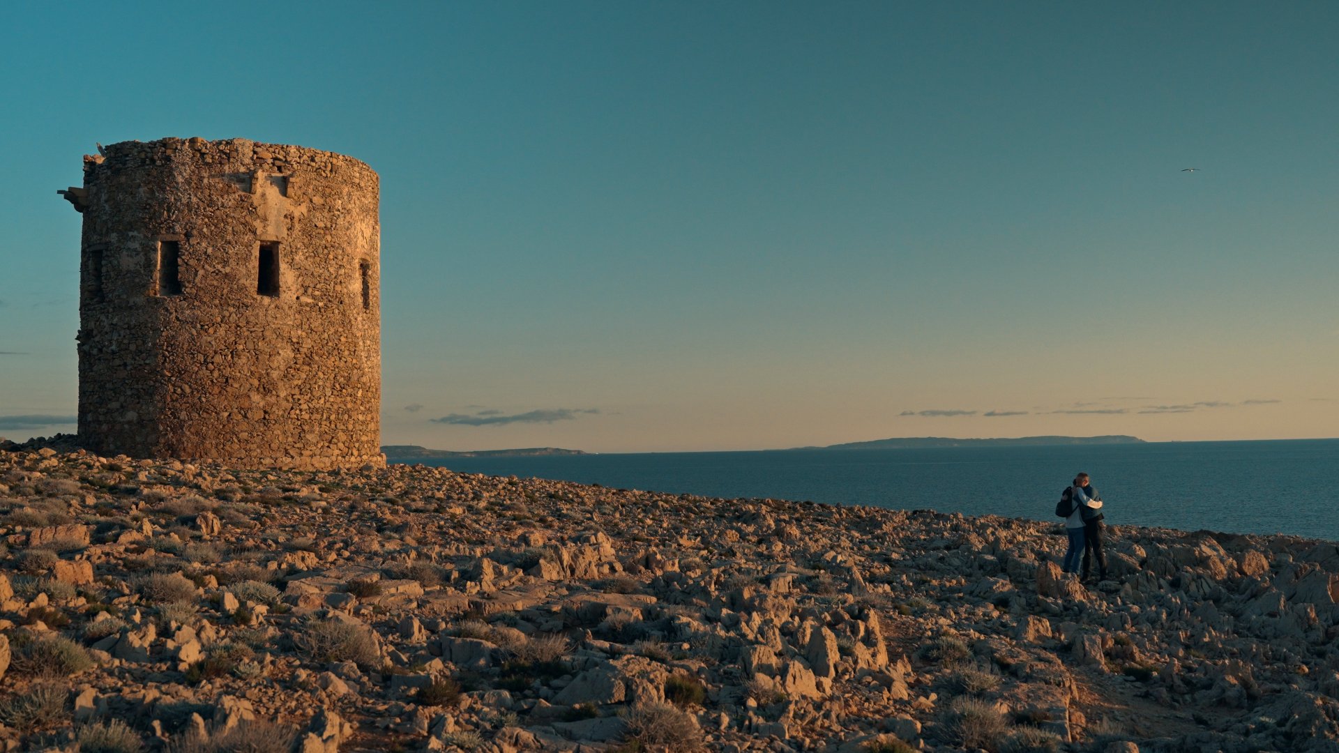 A coastal watchtower at sunset, ungraded flat footage